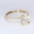 This is an 18k Yellow Gold Engagement Ring with a Central Oval Diamond, accented by Round Diamonds. Center Stone - 1x Oval...