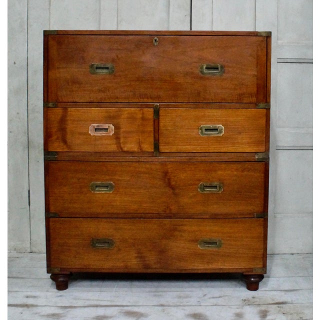 A superb quality teak military campaign secretaire. Made from teak, this set of drawers split into two halves, the top...