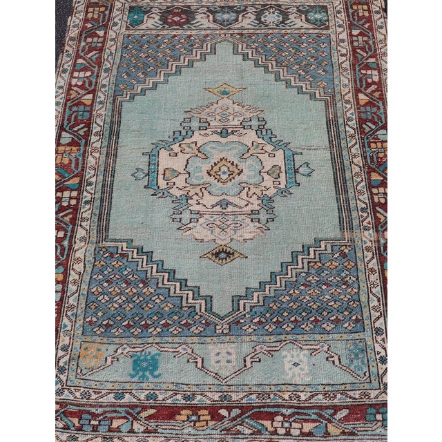 Measures: 3'5 x 5'1 This stunning Vintage Turkish Oushak rug features a vibrant palette of teal and rich maroon,...