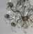 This elegant chandelier features ornate metal arms adorned with cascading glass teardrop crystals, creating a timeless and...