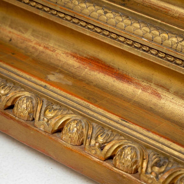 Pair of large wall mirrors in a gold-patinated stucco frame with a strongly profiled moulding. A leaf frieze forms the...
