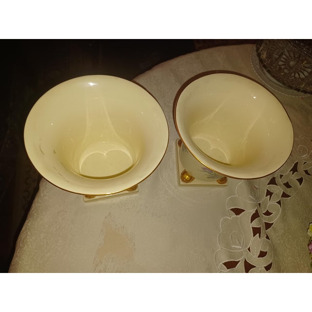 Vintage cache pots/vases with floral design and gold painted claw feet on a base, and gilt edge. 6" H 7" W 7 "D