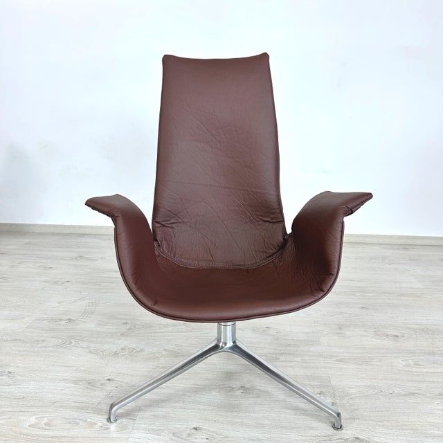 Dimensions: H 41.5” x W 31” x SD 17” x SH 17” Vintage brown leather swivel tulip chair designed by Preben Fabricius &...