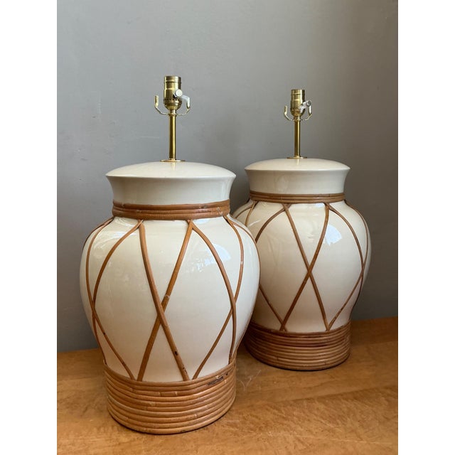 This elegant pair of vintage ceramic and rattan table lamps beautifully captures the relaxed sophistication of mid-century...