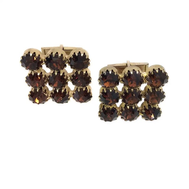 This is a pair of 1960s unisex topaz rhinestone cufflinks. They are Art Deco style large squares composed of nine pcs of...