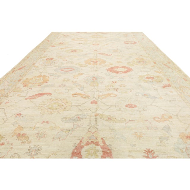 Elevate your living space with the elegance of this Modern Oushak Style rug. Hand-knotted from premium wool, it features a...