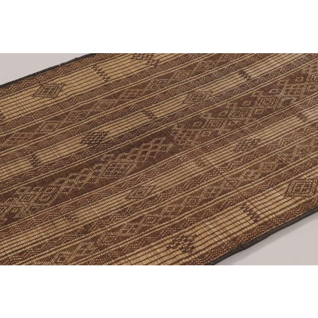 Made with handwoven reed and camel leather in Mauritania circa 1950-1960, this 3x5 vintage Tuareg mat is an exceptional...