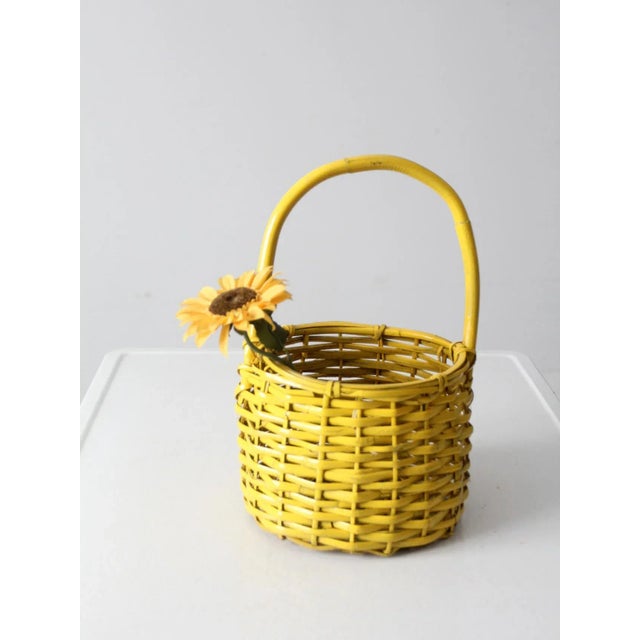 Bring a pop of color to your room with this is vintage wicker handle basket. The bright sunflower yellow basket is a...