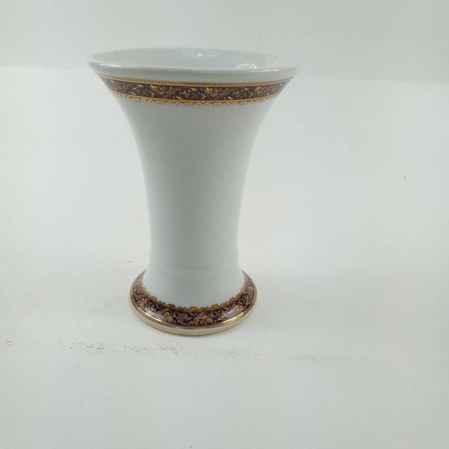 This is an elegant neoclassical-style porcelain vase featuring a striking Medusa (Bacchus) motif, executed in rich cobalt...