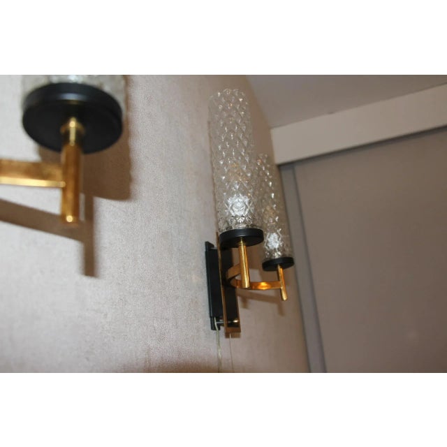 This beautiful pair of French mid-century sconces in the style of Maison Arlus and Lunel, features textured glass tubes on...