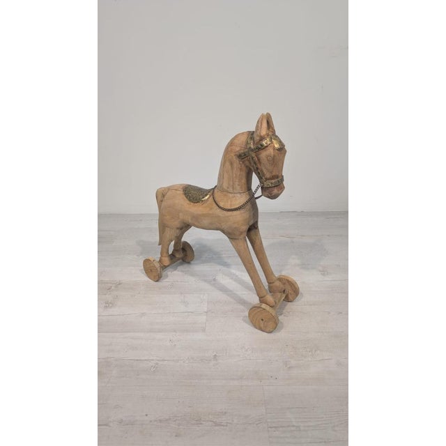 Antique Trojan Horse in Teak and Brass Antique wooden horse on wheels in the Trojan style. Made of teak and brass, it...