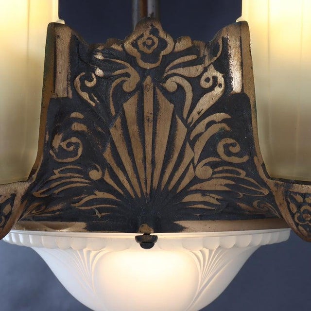 An elegant antique Art Deco five-light chandelier, dating to circa 1930, presents a sophisticated blend of bronze-finished...