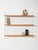 Scandinavian wall shelf system from the 1960s with white lacquered iron uprights and three adjustable oak shelves. The...