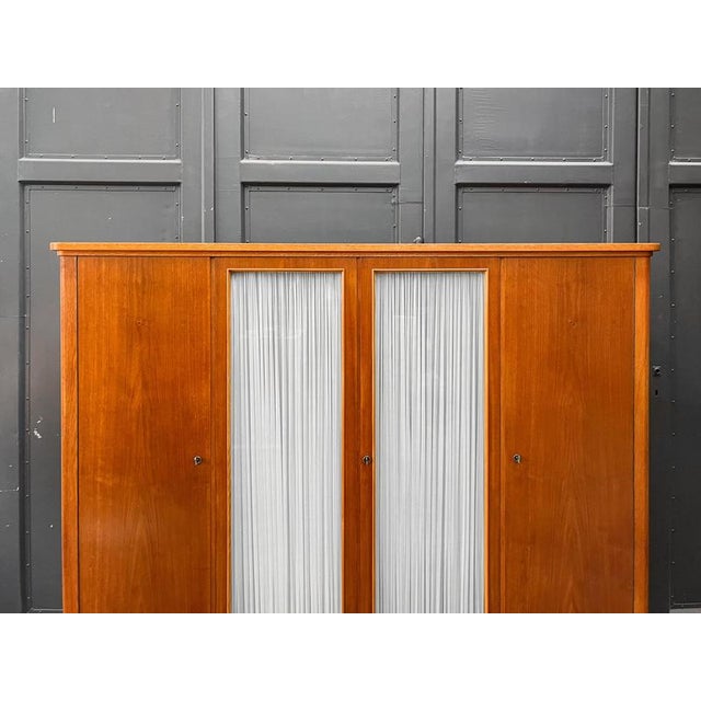 Product: large wardrobe. Style: mid-century, 1960s. Material: oak and walnut veneer. Features: four doors; four removable...