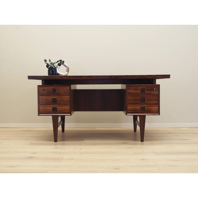 The desk was made in the 1960s, Danish production. The structure and the top are covered with rosewood veneer. The legs...
