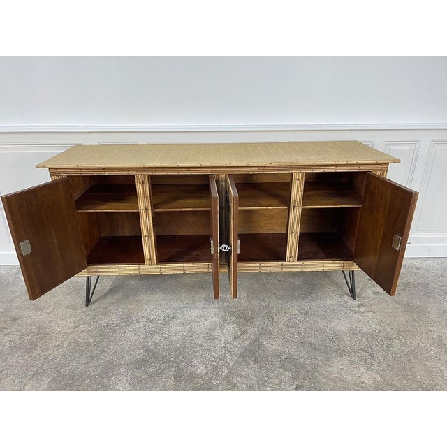 Very beautiful rattan rod with metal zone feet dating from the 1960s. Associated to the couple of French designers Audoux...