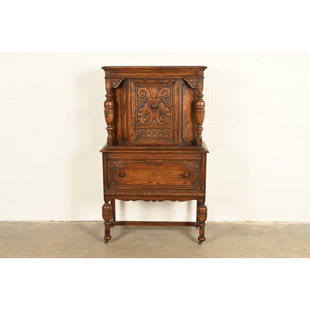 An exceptional antique English Jacobean, Tudor, Victorian, or Renaissance Revival style bar cabinet or dining cabinet By...