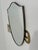 The Vintage Italian Brass Shield Mirror from the 1970s is a sleek and striking piece that epitomizes the bold design...