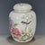This is a charming vintage porcelain tea jar (盖罐), decorated in the famille rose (粉彩) palette with vibrant polychrome...