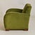 A 1950s Italian lounge chair defined by its Art Deco silhouette. The form is sculpted with dramatic curvesrounded arms...