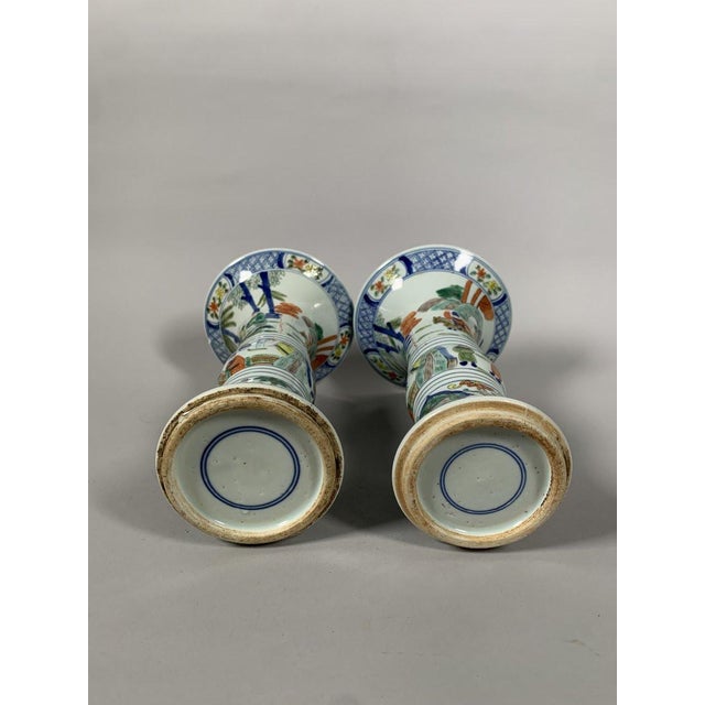 Pair of Gu porcelain vases, 19th century , Chinese style. Wucai-style glazed enamel decoration of horsemen in an imperial...