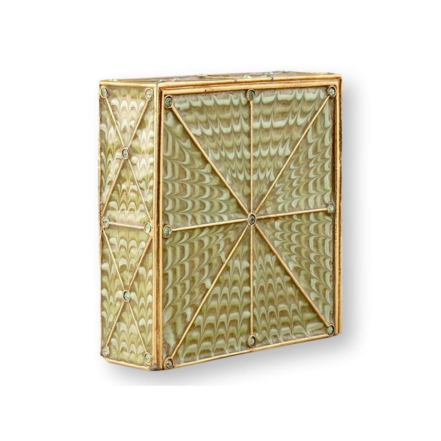 A late 20th century Jay Strongwater enameled desk clock featuring a gilt metal frame with hand-applied enamel panels and...