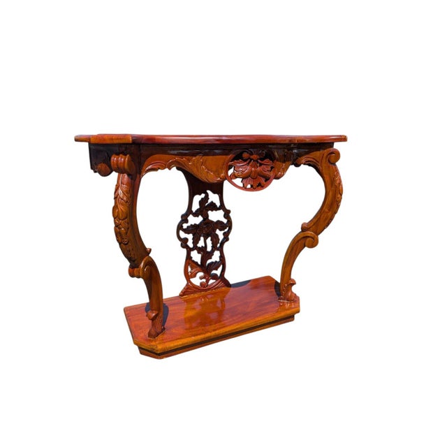 A dramatically carved Rococo Revival style entryway console table, built to stand flush against a wall and make a...