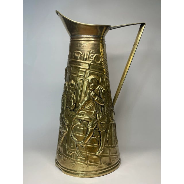 This English made embossed brass pitcher tells the story of an English pub scene of a group of men having a pint or dram....