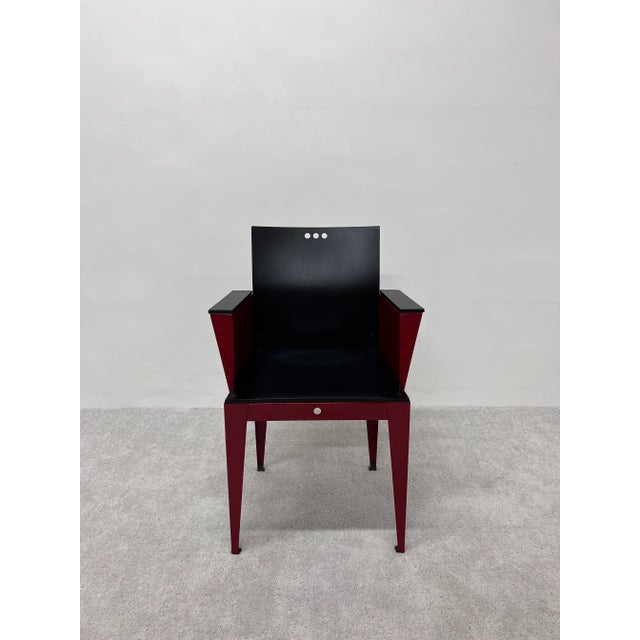 Rare Eli armchair with matte black maple wood seat, back and arms attached to a red lacquered steel base. Designed by...