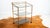 Vintage faux bamboo and smoked glass three-tier rolling bar cart, circa 1970s. Crafted from polished brass-finished metal...