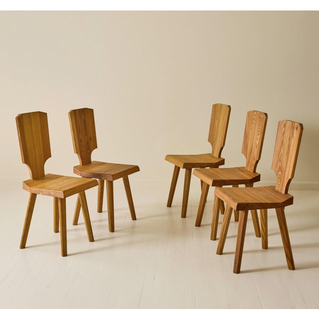 A set of six chairs, model “S28,” designed by Pierre Chapo in 1972 and crafted in solid elm. Each chair is distinguished...