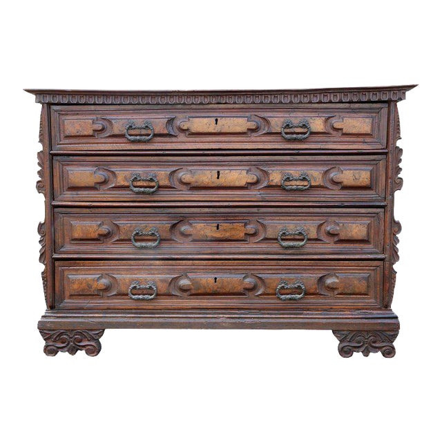 Rectangular top over four graduated panelled drawers with original carved feet and applied carving to side of case....
