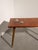 Charming vintage coffee table featuring elegant mid-century modern lines and decorative fish inlays on the tabletop....