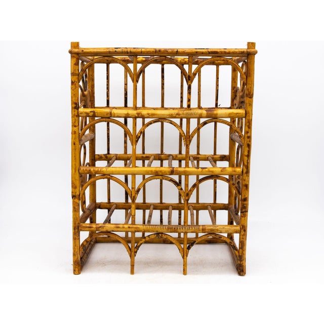 This vintage Hollywood Regency tortoise bamboo rattan wine rack is a charming and practical addition to any home. It...