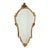 A fantastic gold-colored deknudt mirror with a decorative crest and beveled glass, executed in the classic louis xvi...