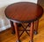 A Mid Century Modern table with the unusual design of having six legs. It is made from mahogany with dark iron shoes and a...