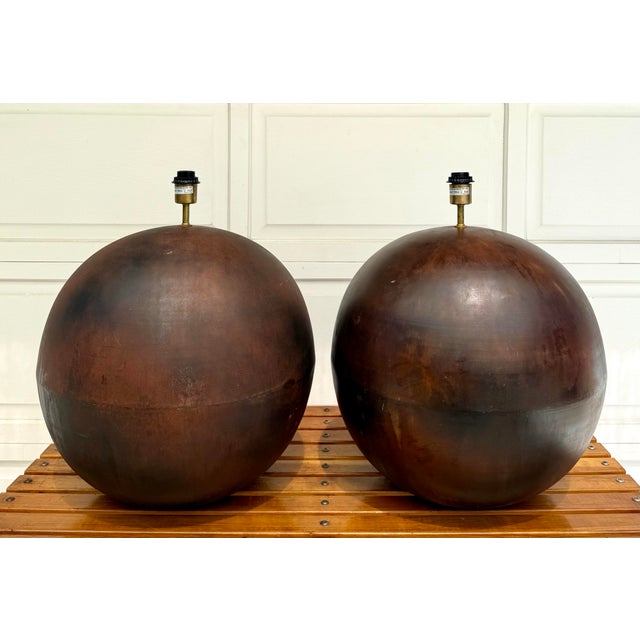 Here is a pair of rustic, patinated sphere shaped table lamps in the style of Robert Kuo. The lamps are big and beautiful,...