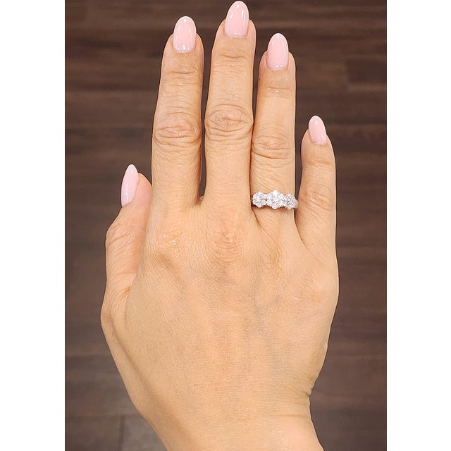 This stunning 18k white gold ring features 21 round brilliant diamonds totaling 0.97 carats. Each diamond is graded F/G...