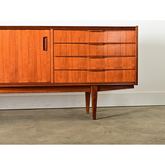 French Mid-century Modern (circa 1960) walnut sideboard of undeniable Scandinavian-Danish inspiration, to offer practical...