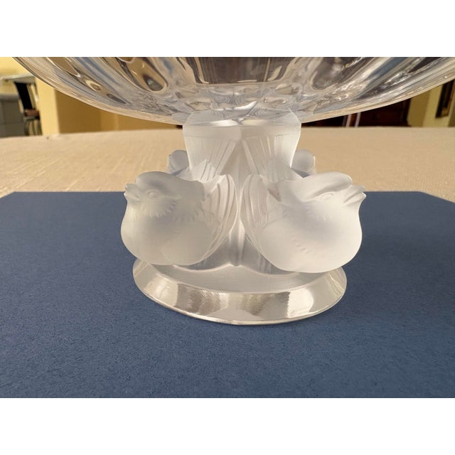 This clear, fluted crystal bowl resting on a pedestal formed by four frosted glass sparrows is accompanied by two...