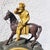 A bronze clock with a double patina, depicting Napoleon I on horseback, gazing into the distance through his telescope. On...