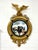 A classic Federalist style mirror with an impressive sculptural form of a gilded eagle excited into flight that crowns the...