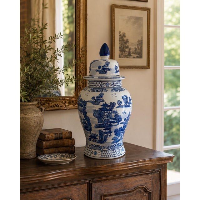 A large blue and white porcelain ginger jar decorated with continuous Chinoiserie landscapes of pagodas, garden pavilions,...