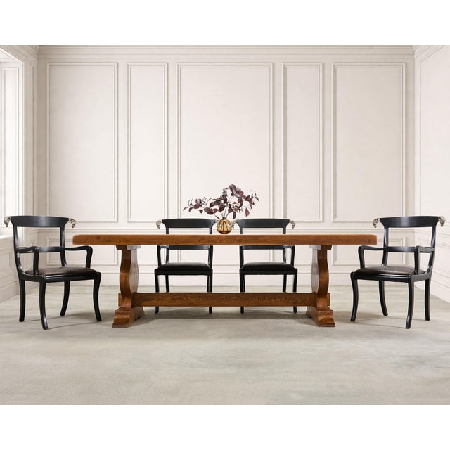 A substantial rustic country French Provincial style oak trestle dining table, crafted with a thick rectangular plank top...