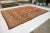 Beautiful modern Sultanabad hand-knotted wool rug with a red-rust color field. This rug has a brown designed frame with...