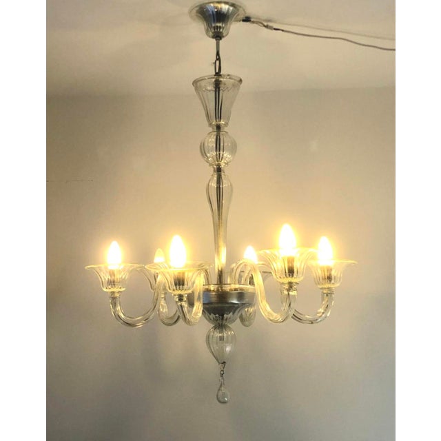 For 6 E14 bulbs/LEDs. Modular elements also make other looks possible, e.g. last photo. This piece has an attribution...