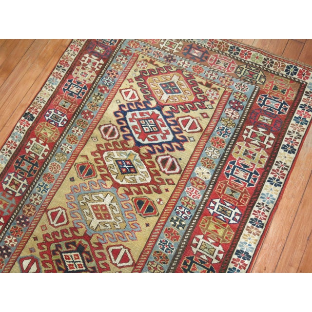 A rare size Caucasian runner with a camel field, accents in green, red, blue. Measures: 3'1'' x 8'3'' Older Caucasian...