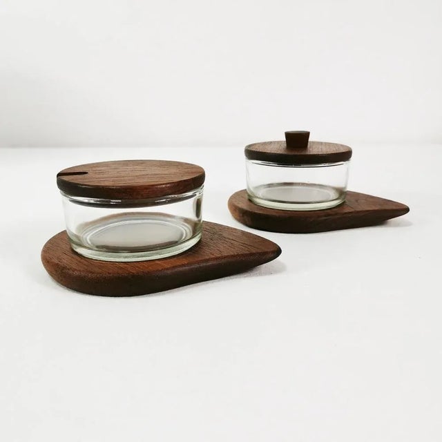Sugar bowls (set of 2), origin Denmark, 1960s They are characterized by a modernist, economical form. Made of teak wood...