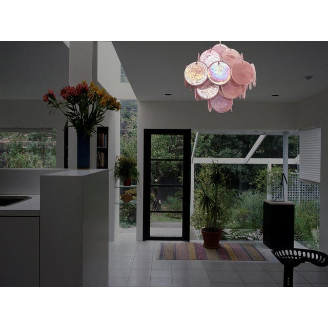 Vintage Italian Murano chandelier in Vistosi style. The chandelier has 36 fantastic iridescent alabaster pink discs in a...