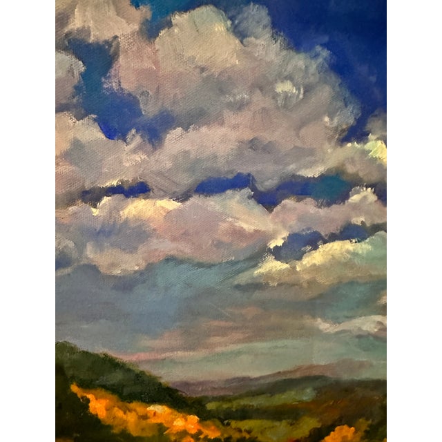 Beautiful bright blue sky landscape painting on canvas. Looks like it could be the fall season with some orange leafed...